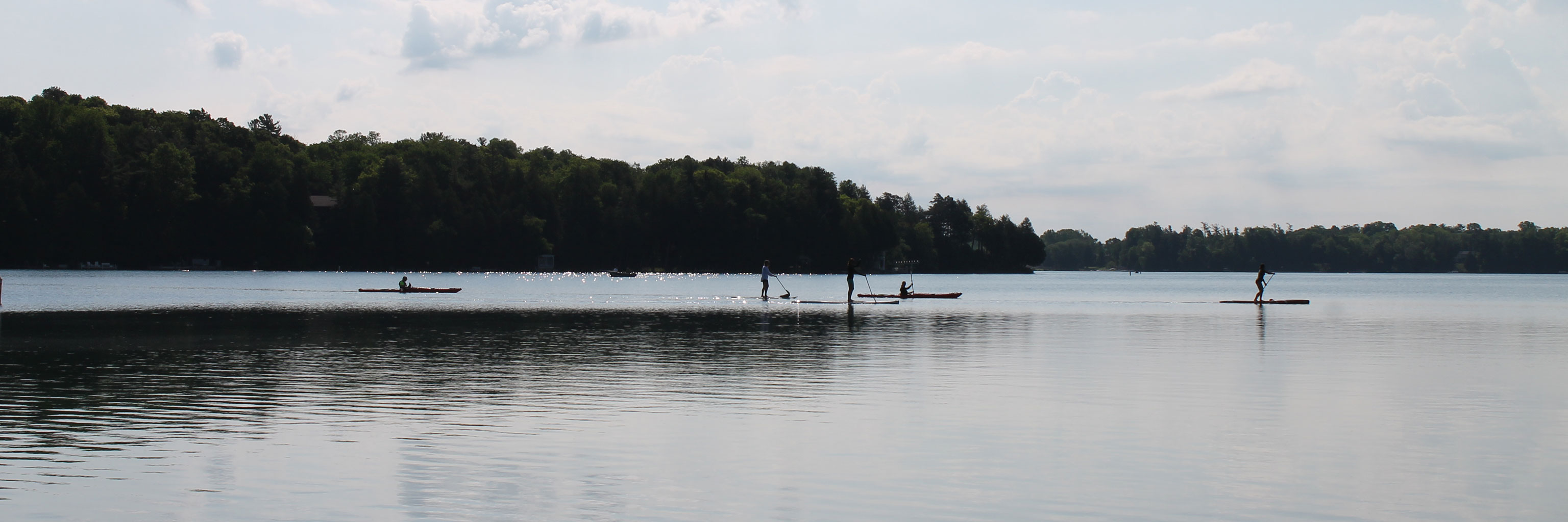 students paddle boarding on Elkhart Lake 